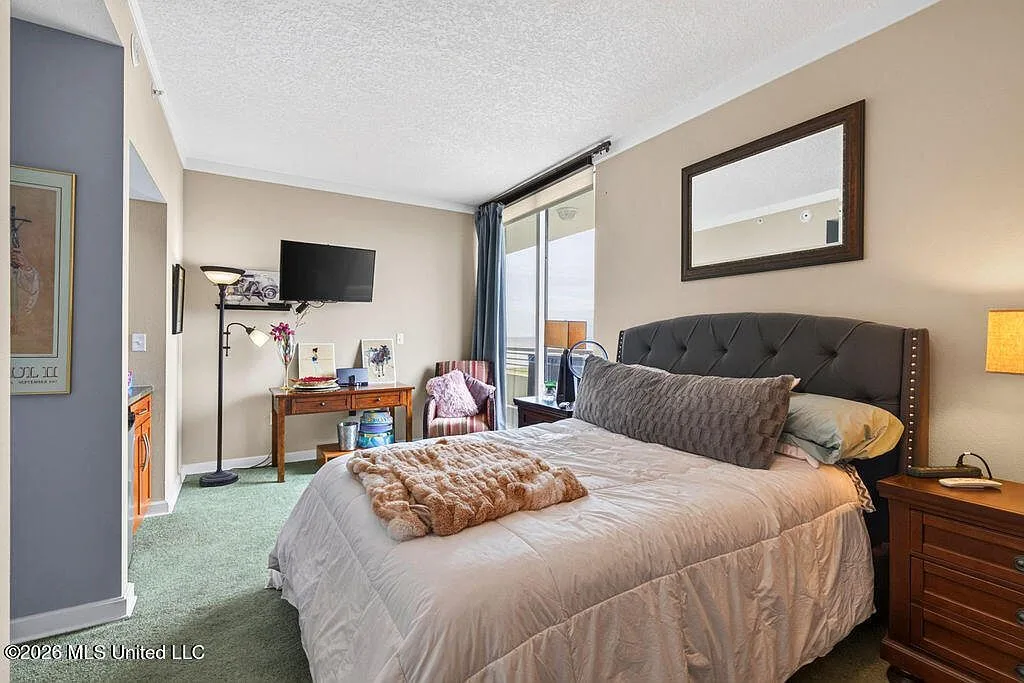 Primary bedroom with sliding glass door to balcony