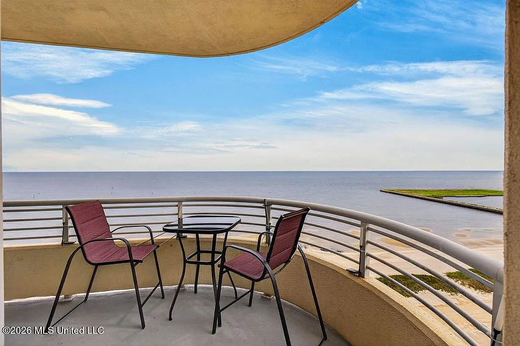 High-floor balcony with curved railing and ocean views
