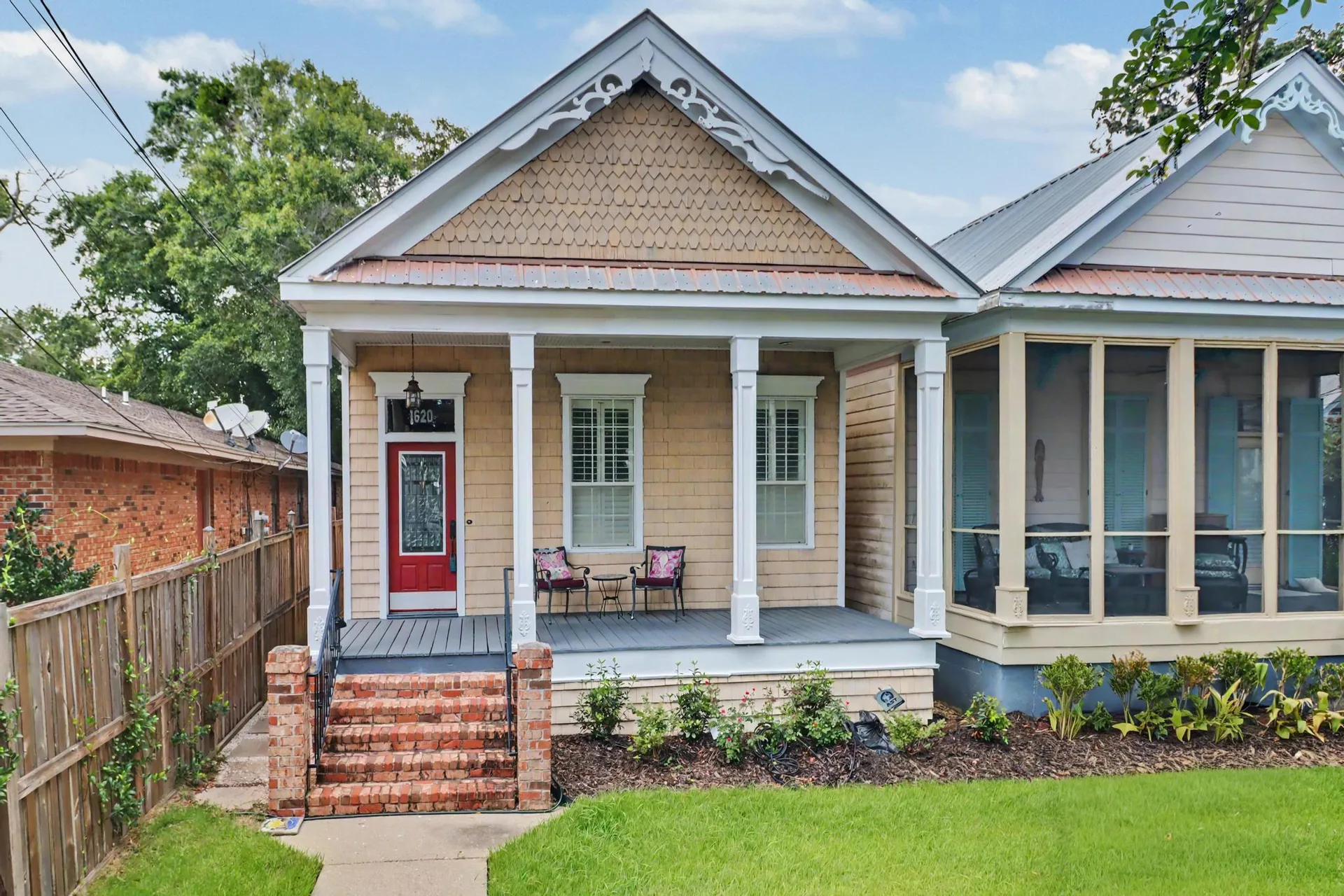 1620 2nd St, Gulfport, MS 39501 — exterior facade with gingerbread trim, brick entry steps, and a red front door