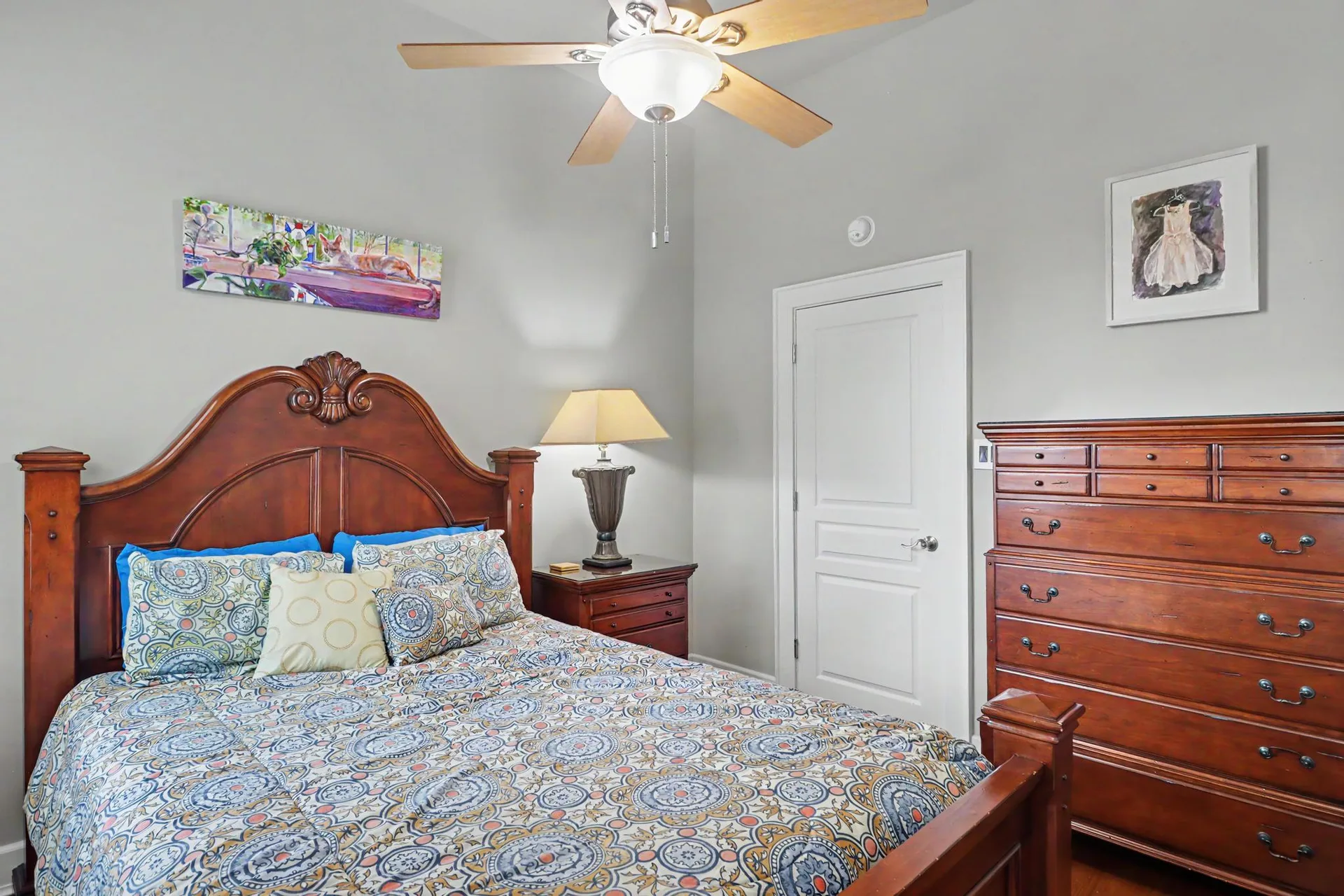 Master bedroom with wooden furniture, high ceilings, and heart pine floors