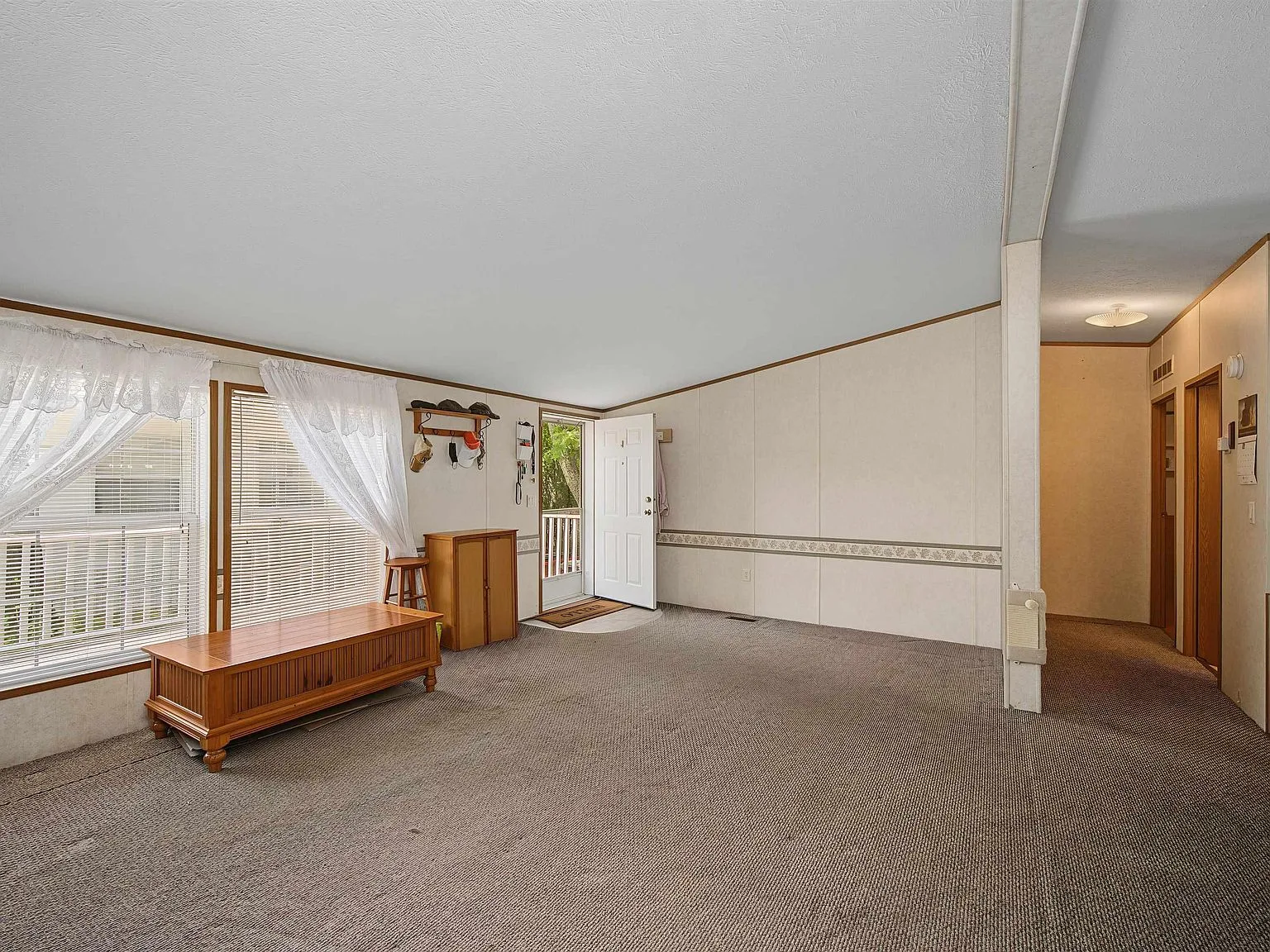 Wide-angle living room with vaulted ceilings and natural light