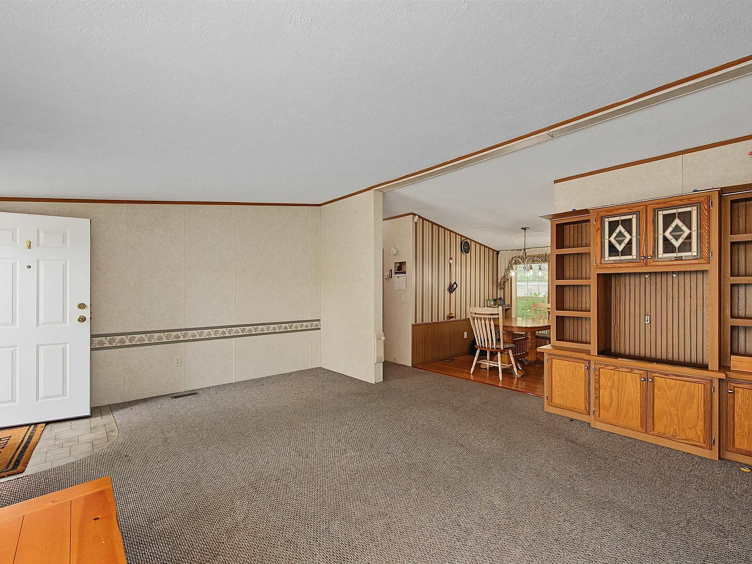 Living and dining area with built-in media center cabinetry