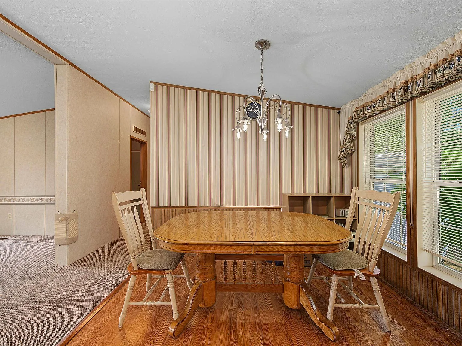 Dining room with wood laminate flooring and side windows