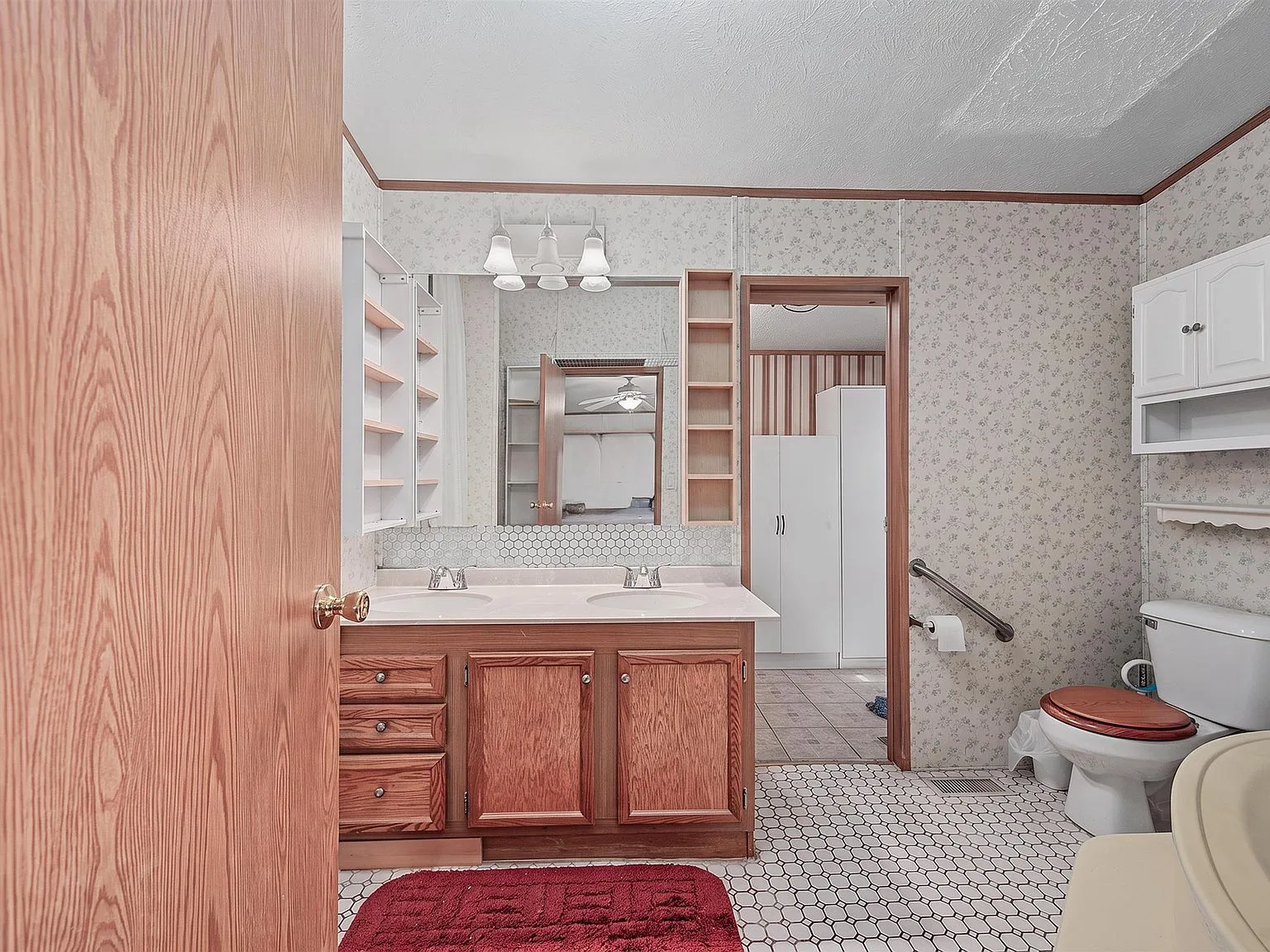 Primary bathroom with wood vanity and hexagonal tile floor