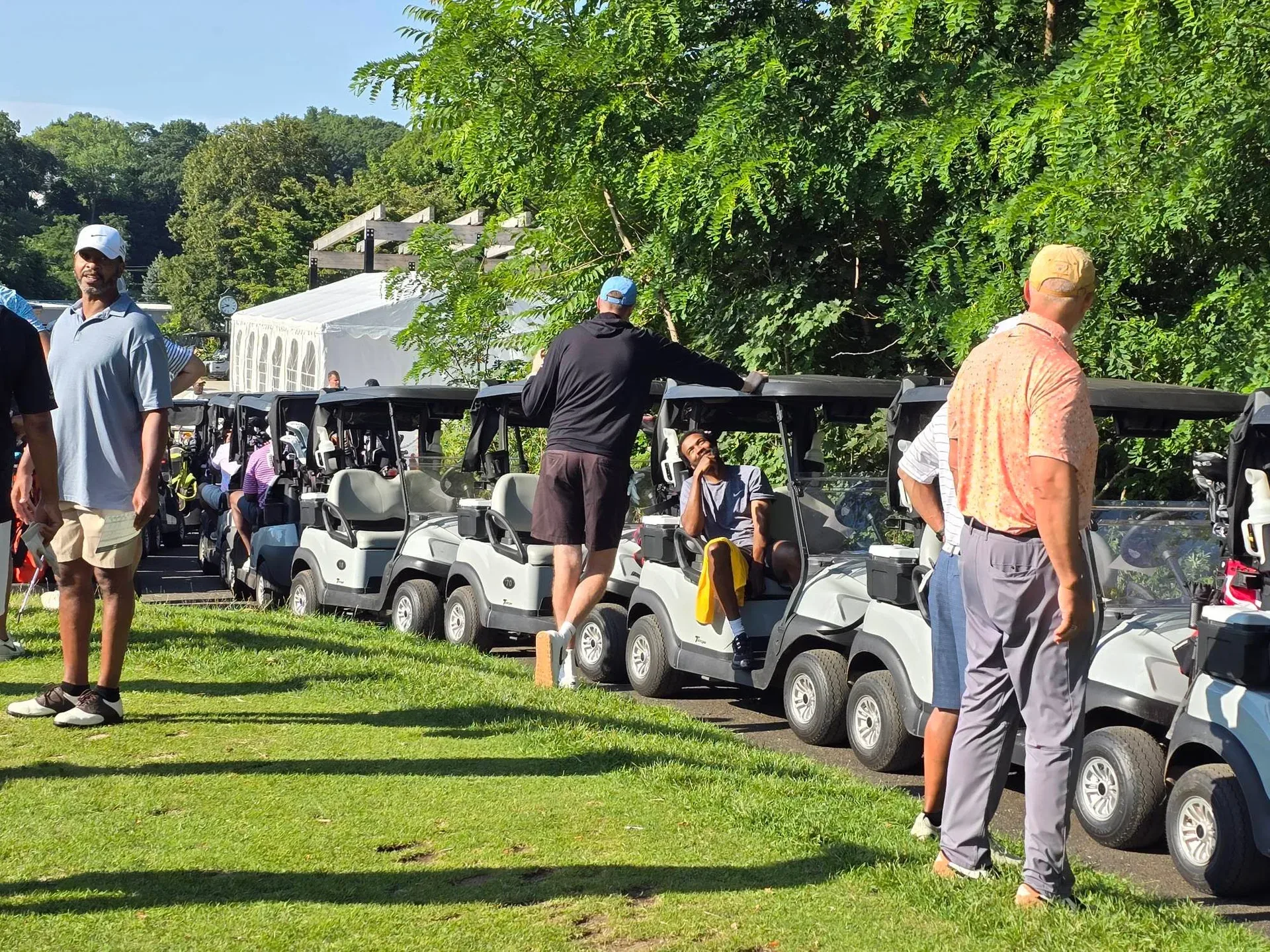 Row of golf carts lined up and ready for the start of the 82nd Annual Knickerbocker Golf Club Scholarship Tournament at Alling Memorial Golf Club