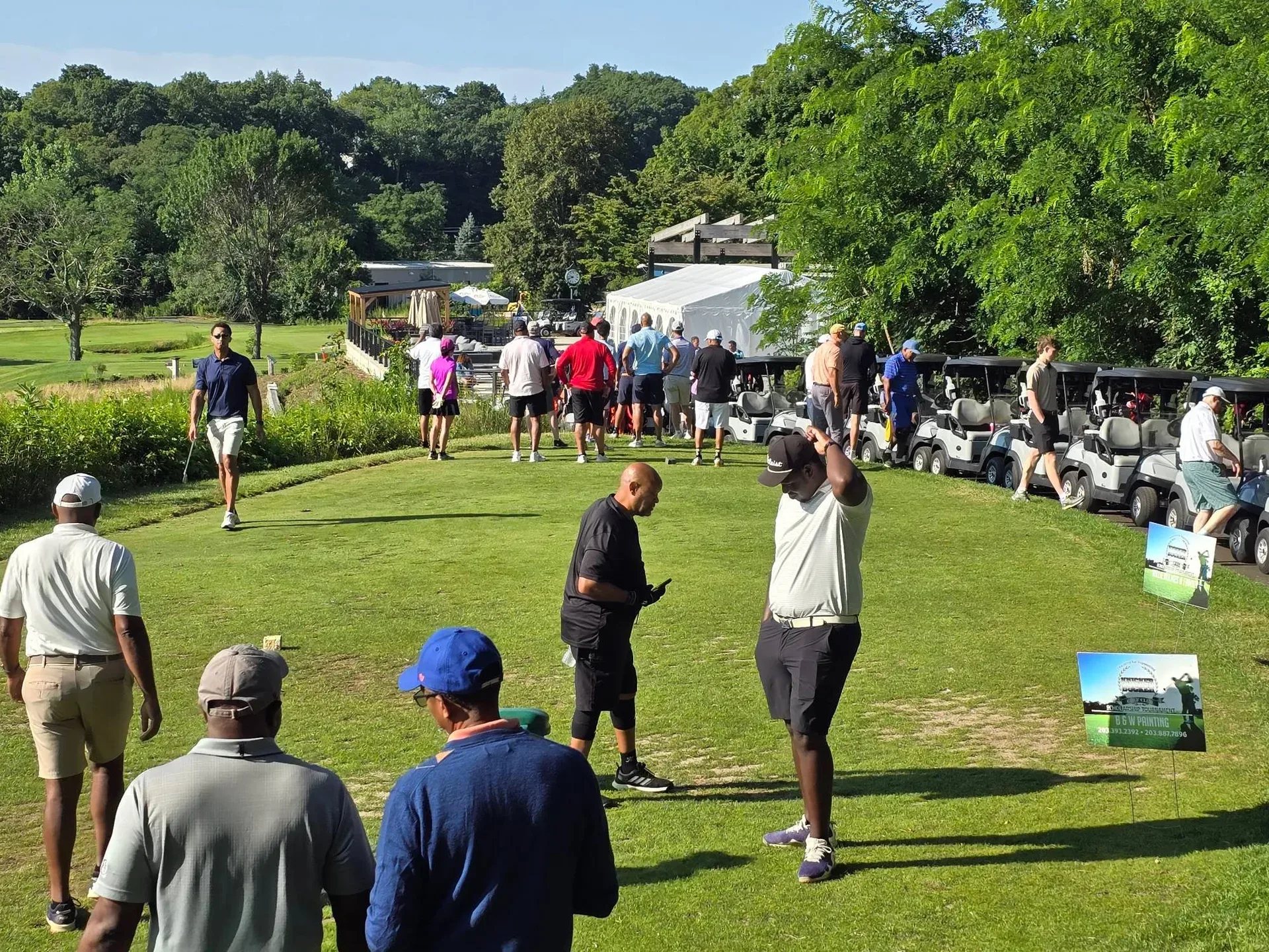 Golfers checking in at the registration table before the Knickerbocker Golf Club tournament begins