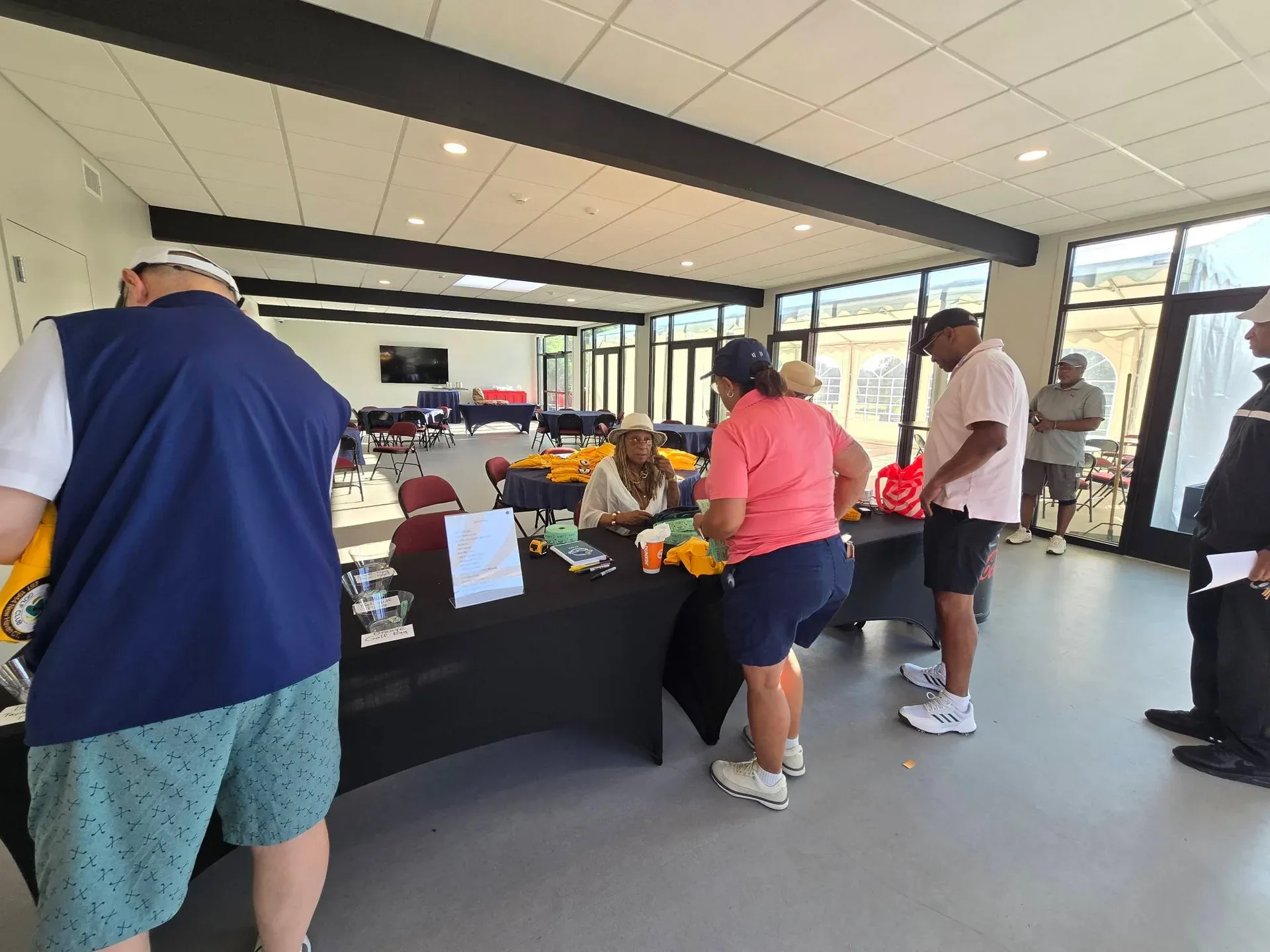Participants gather at the clubhouse for registration and fellowship at the Knickerbocker Golf Club tournament