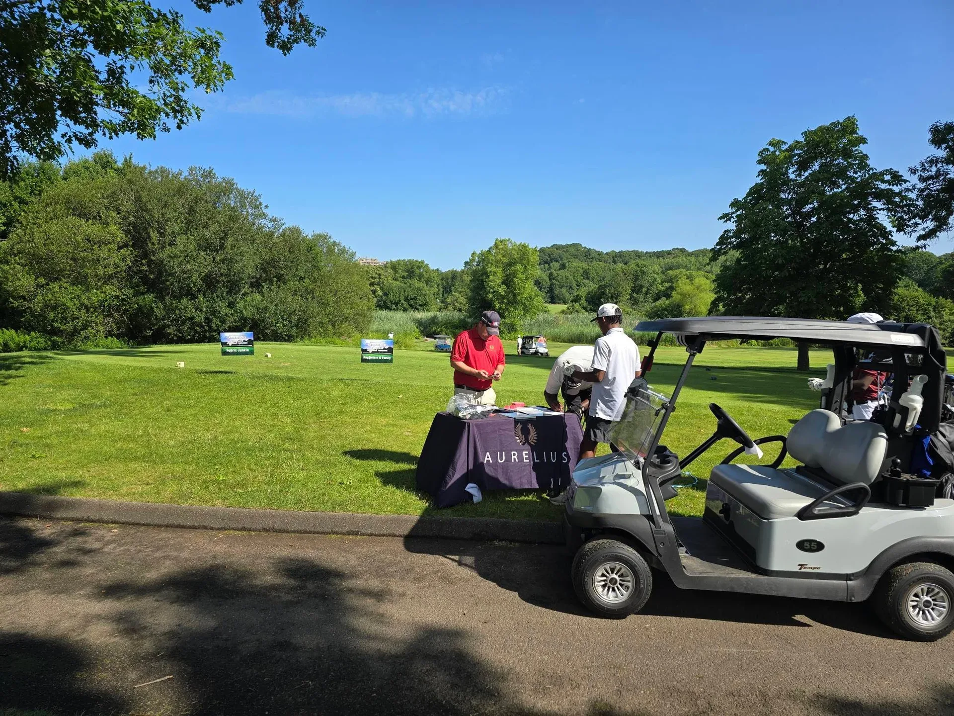 The grounds at Alling Memorial Golf Club on tournament day, showing lush fairways and trees