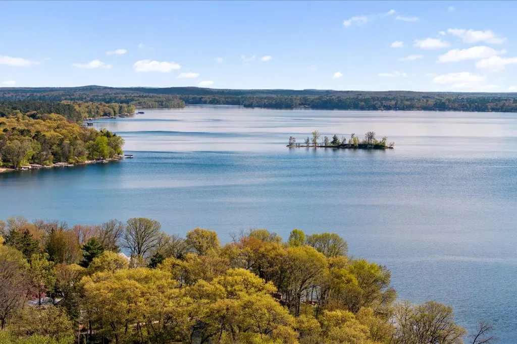 Aerial view across the Whitefish Chain of Lakes with a prominent island and wooded shoreline
