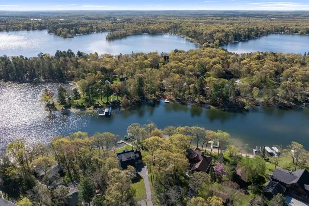 Aerial drone view of the Whitefish Chain of Lakes with forested shoreline and private docks