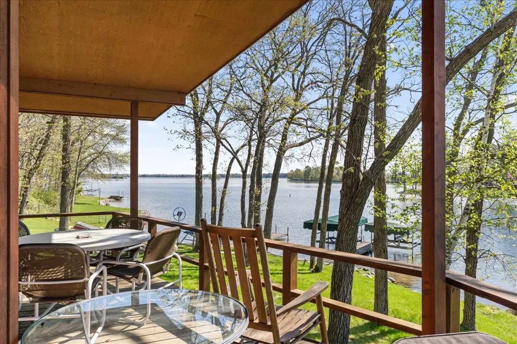 Covered deck with timber-framed architecture overlooking the lake