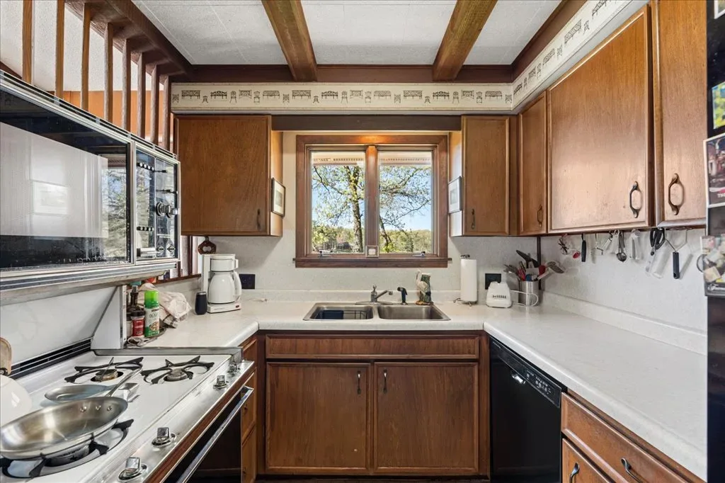 Traditional wood kitchen with cabinetry and natural light from the window