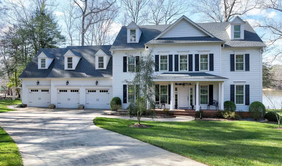 Colonial-style home with white siding and black shutters in Lochmere, Cary NC