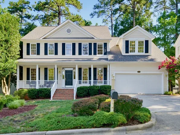 Colonial-style home with cream siding and dark blue shutters in Park Village, Cary NC