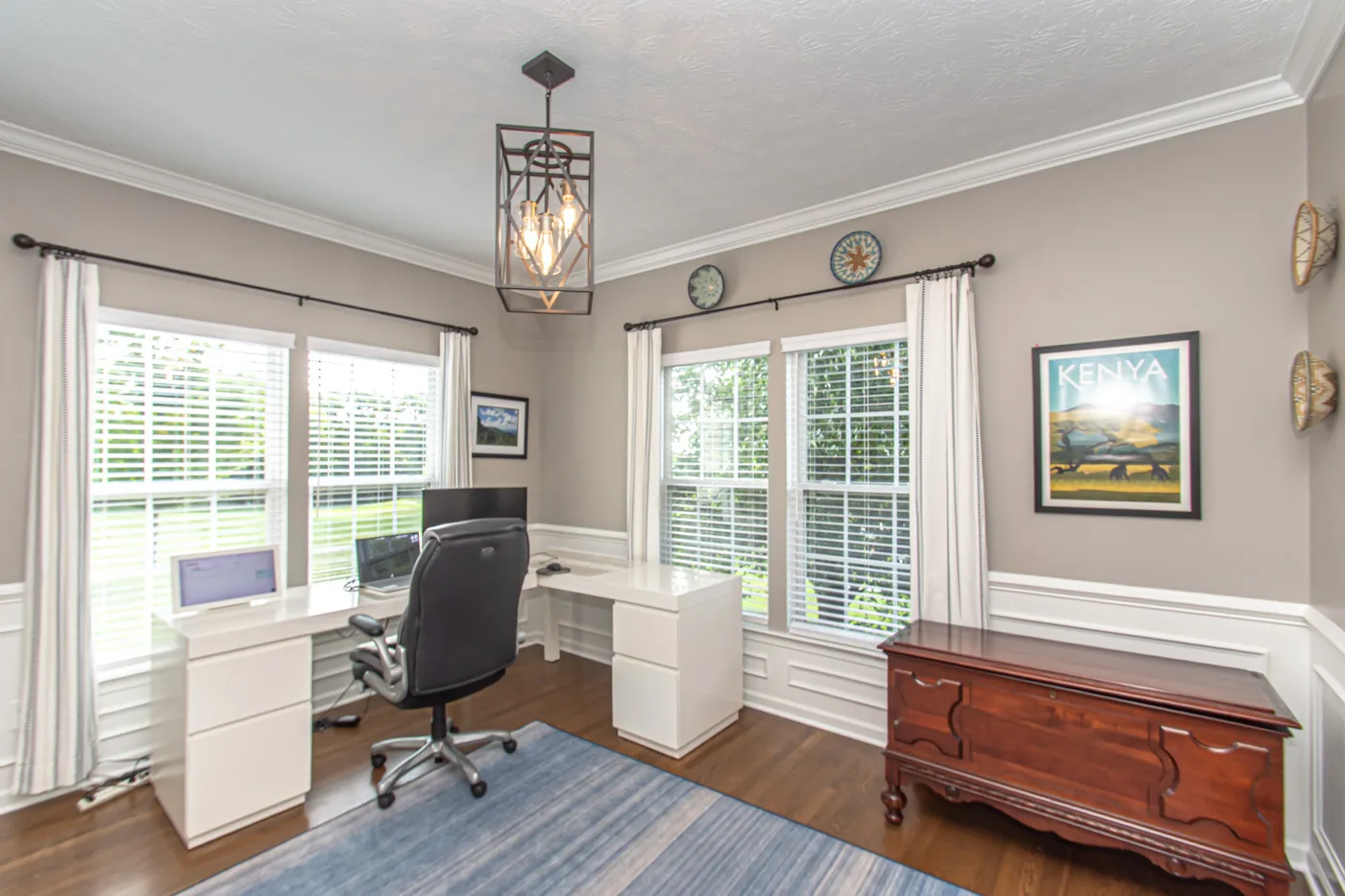 Home office with wainscoting, crown molding, and natural light
