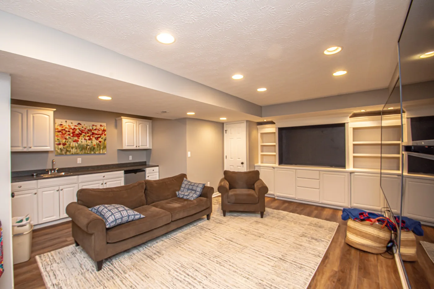 Lower level with wet bar and custom cabinetry