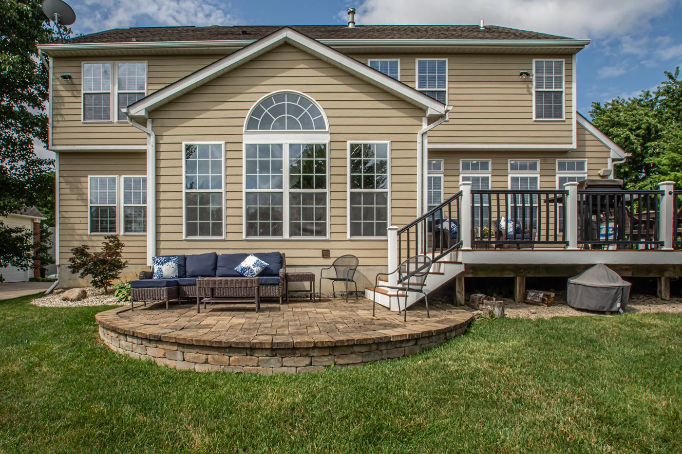 Rear exterior with composite deck and circular paver patio