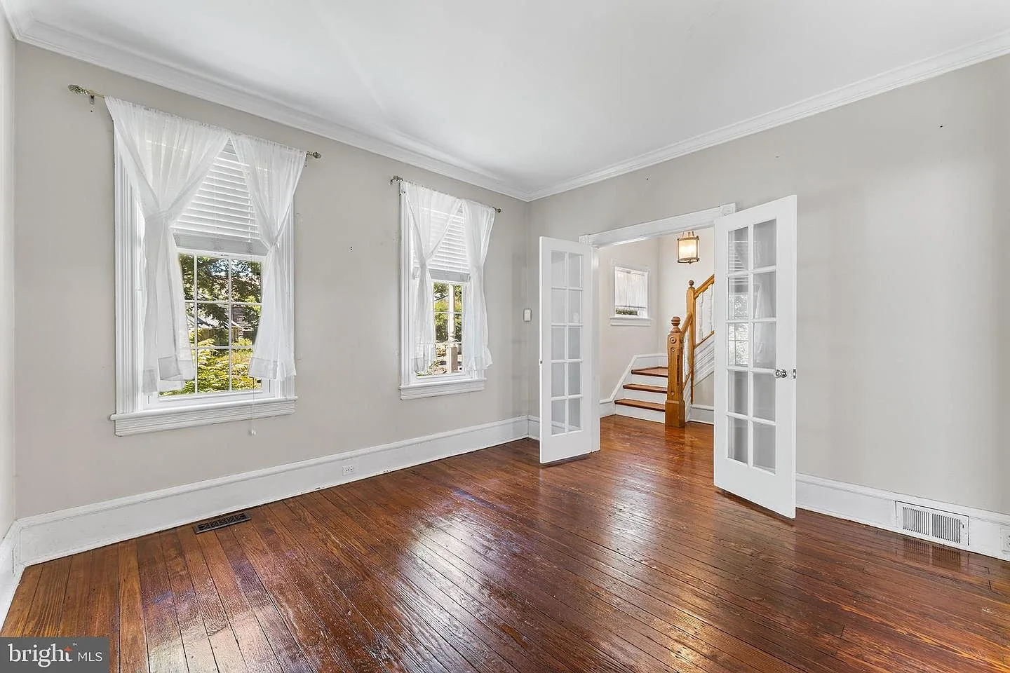 Sitting room with French doors, hardwood floors, and natural daylight