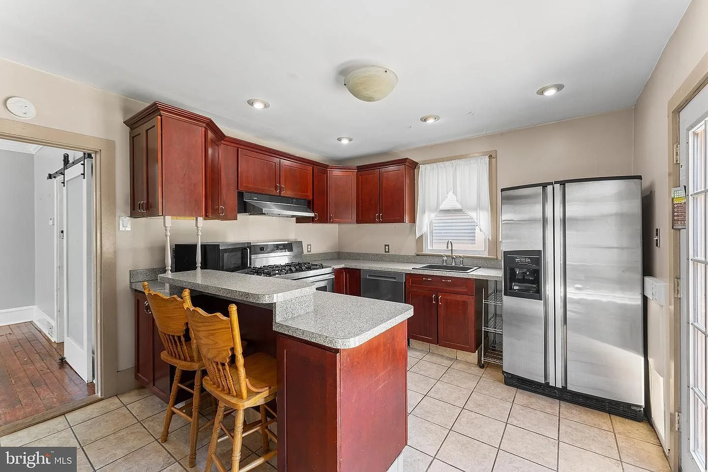 Kitchen with cherry wood cabinetry and stainless steel appliances