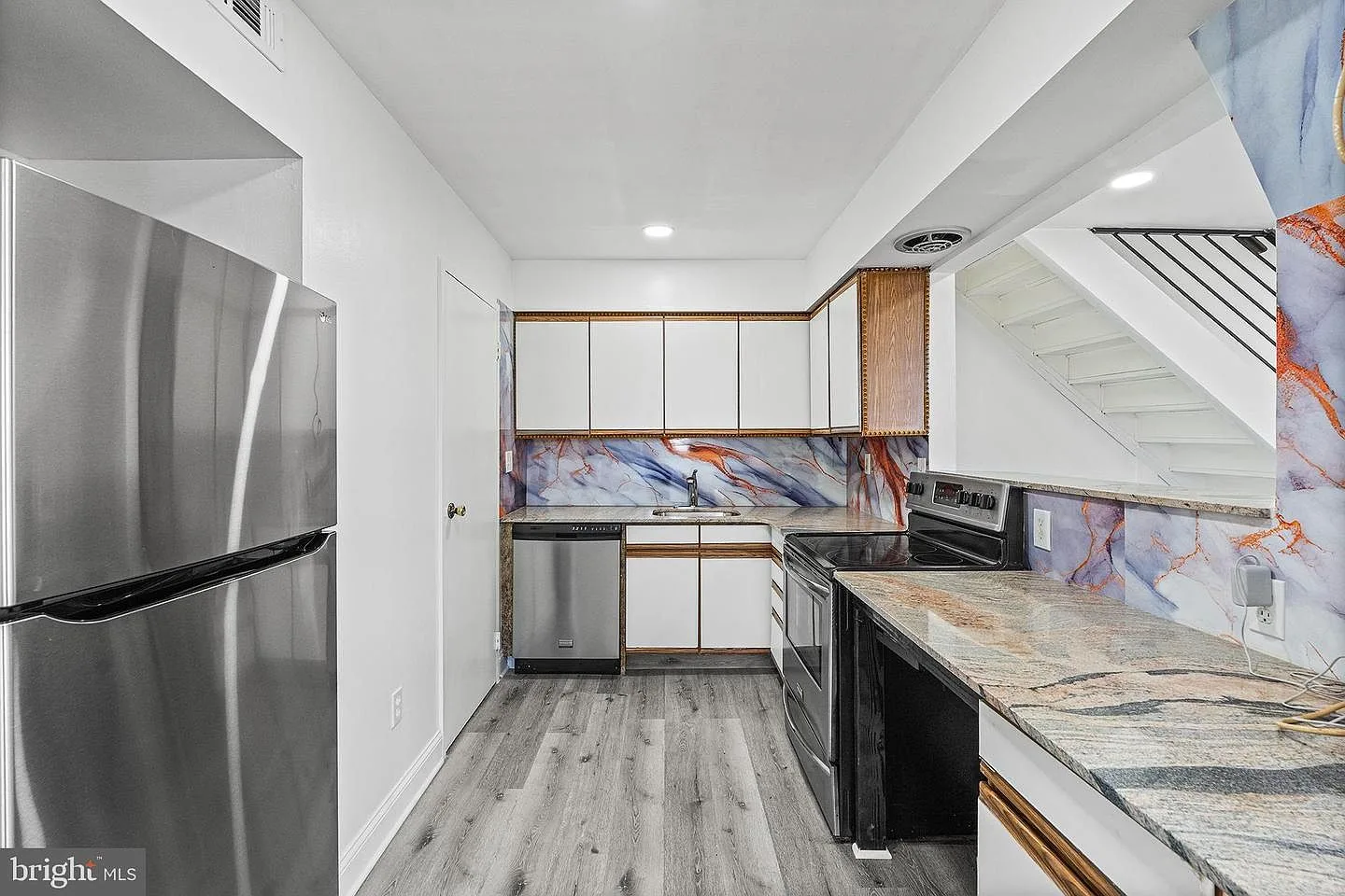 Modern renovated kitchen with granite countertops and stainless steel appliances