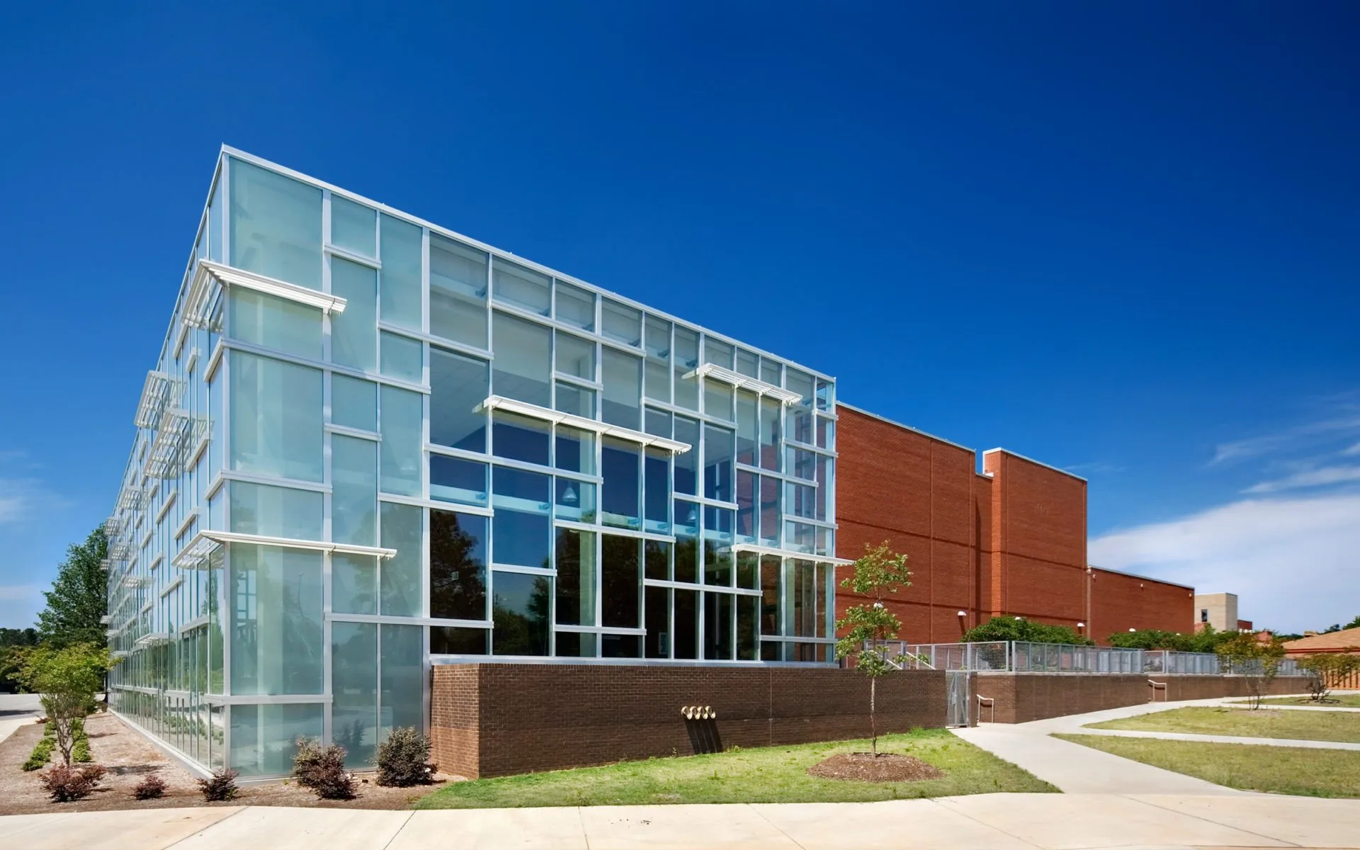 Modern glass and brick facade of a school building in Cary, NC