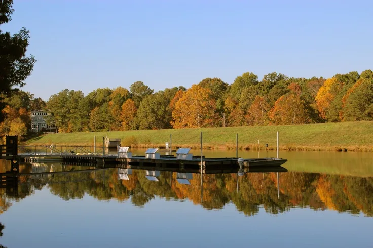 Lake dock with autumn foliage at Fred G. Bond Metro Park in Cary, NC