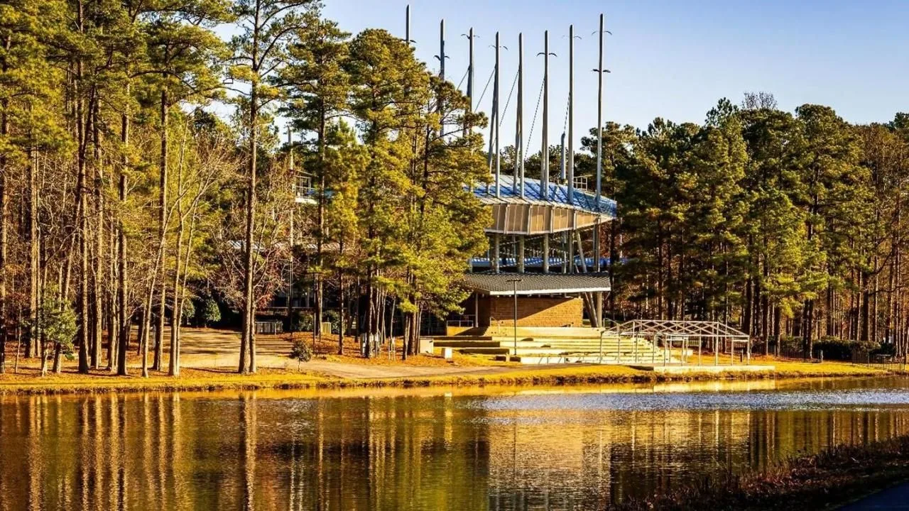 Koka Booth Amphitheatre lakeside exterior in Cary, NC with tall vertical masts and terraced stage