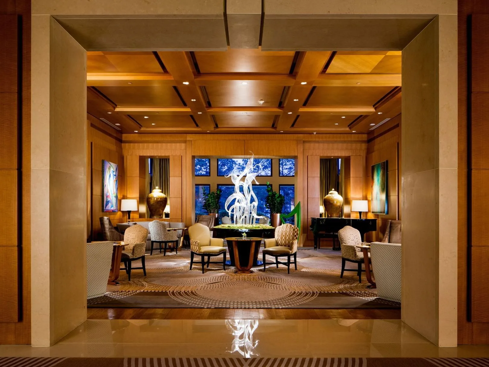 Grand lobby lounge with wood-paneled walls and coffered ceiling in a Cary dining venue