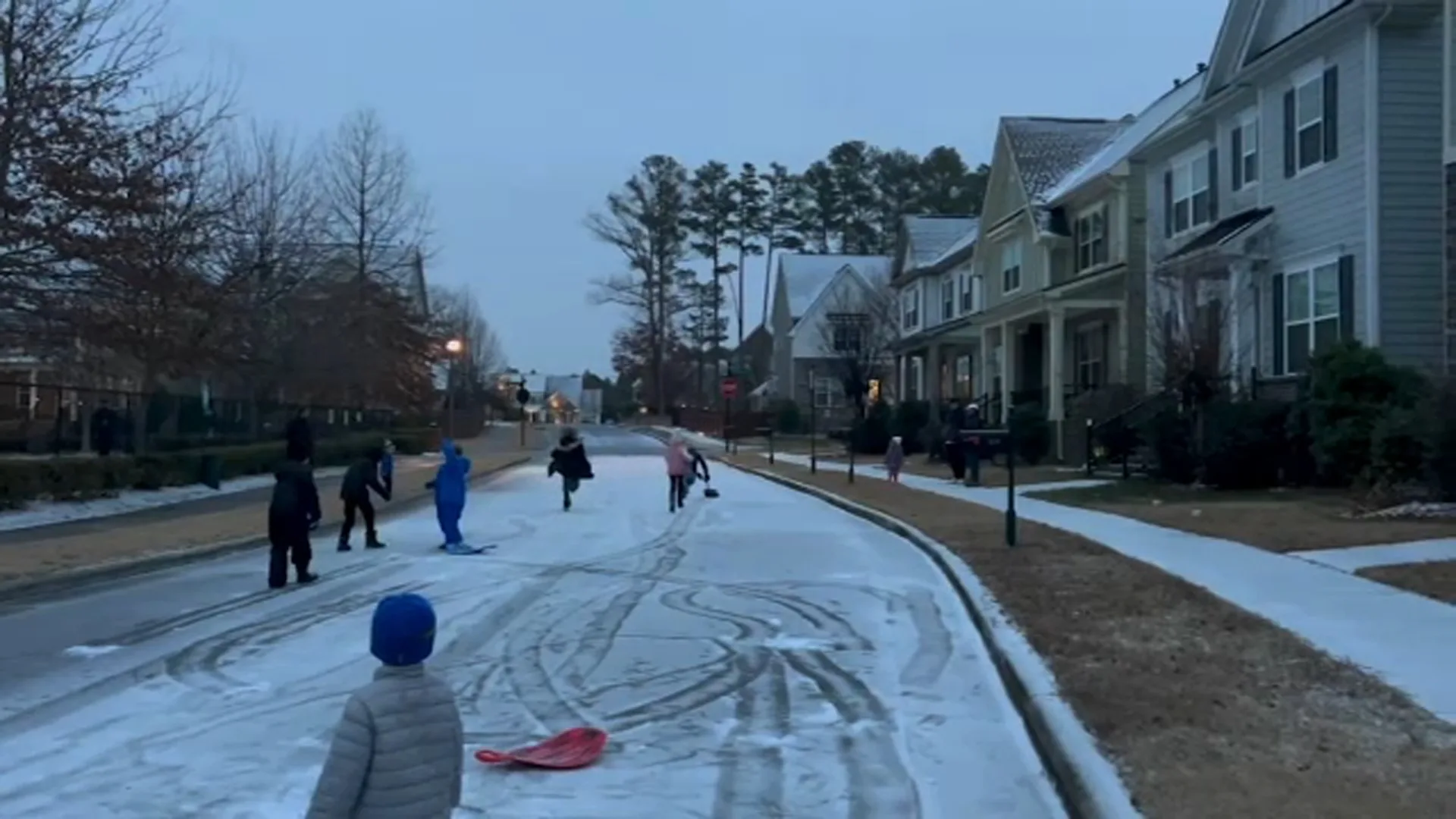 Snowy residential street in a Cary neighborhood during winter