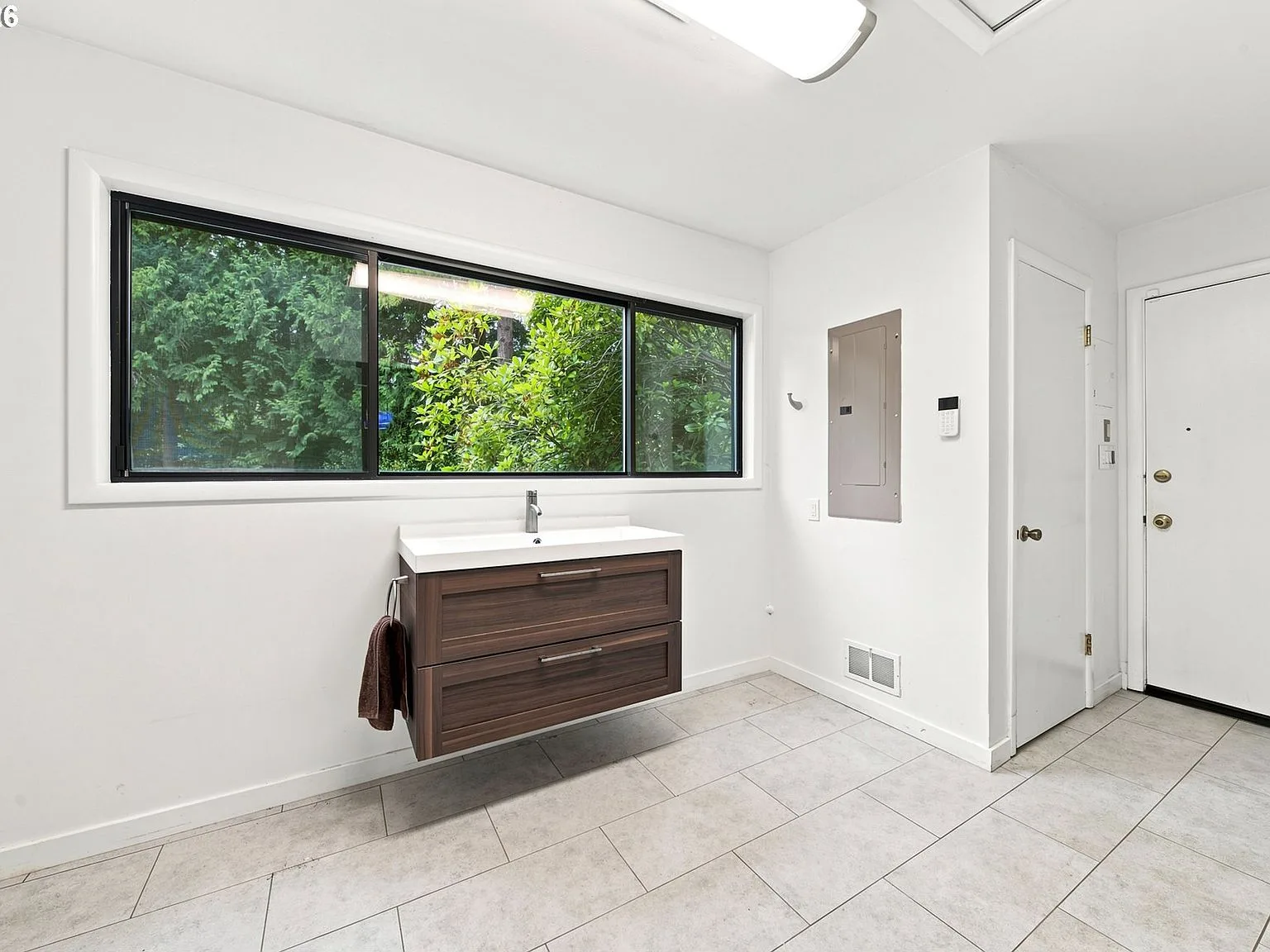 Mudroom/bathroom area with floating vanity and garden window