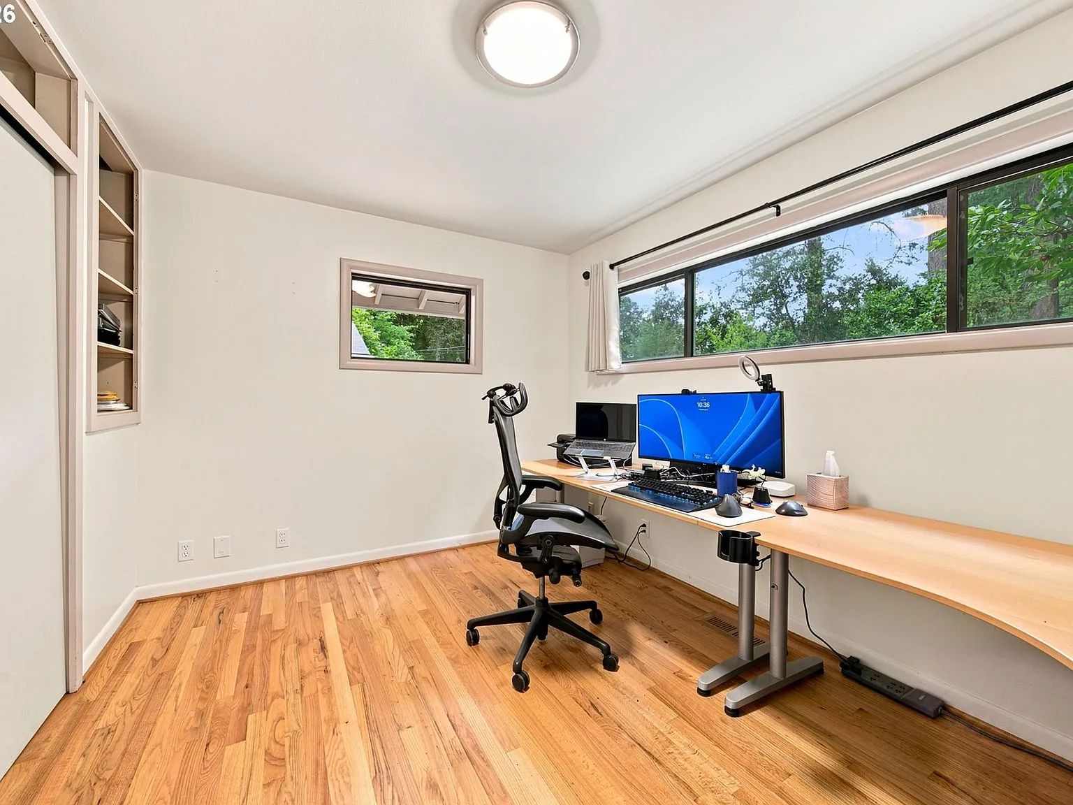 Home office/bedroom with large windows and natural light