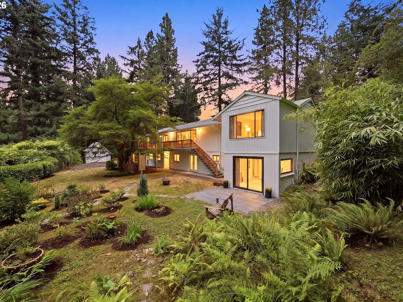 Multi-level home showing walkout basement at twilight