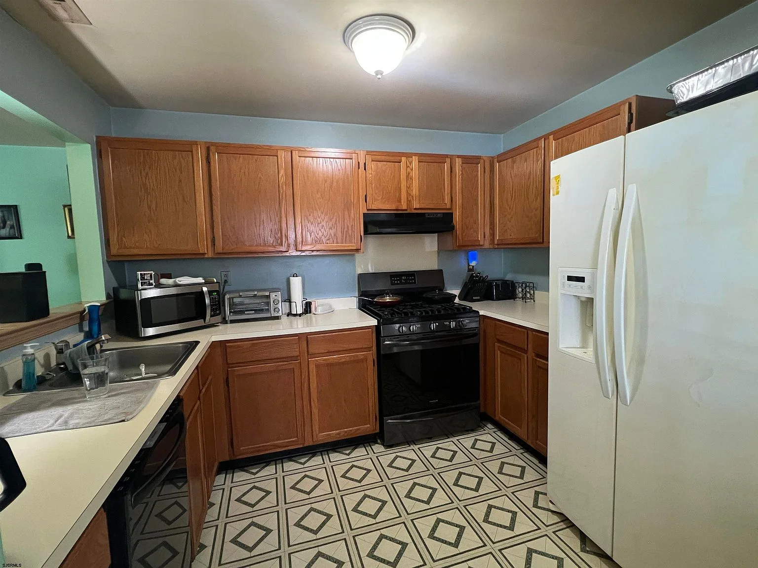 Kitchen with oak cabinets and black appliances