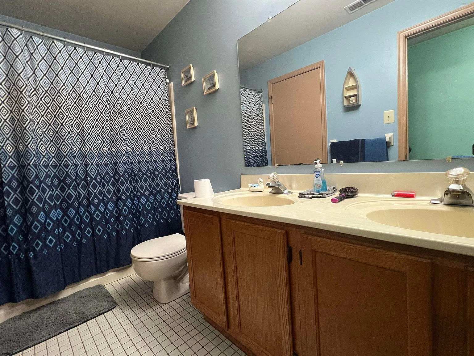Bathroom with dual-sink vanity and wall mirror