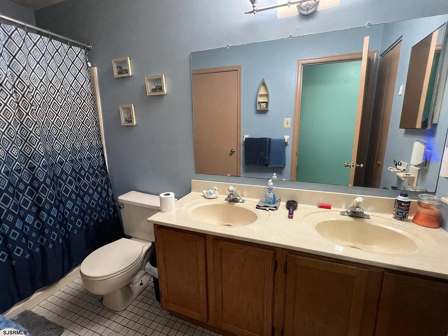 Bathroom with dual-basin vanity and tiled floors