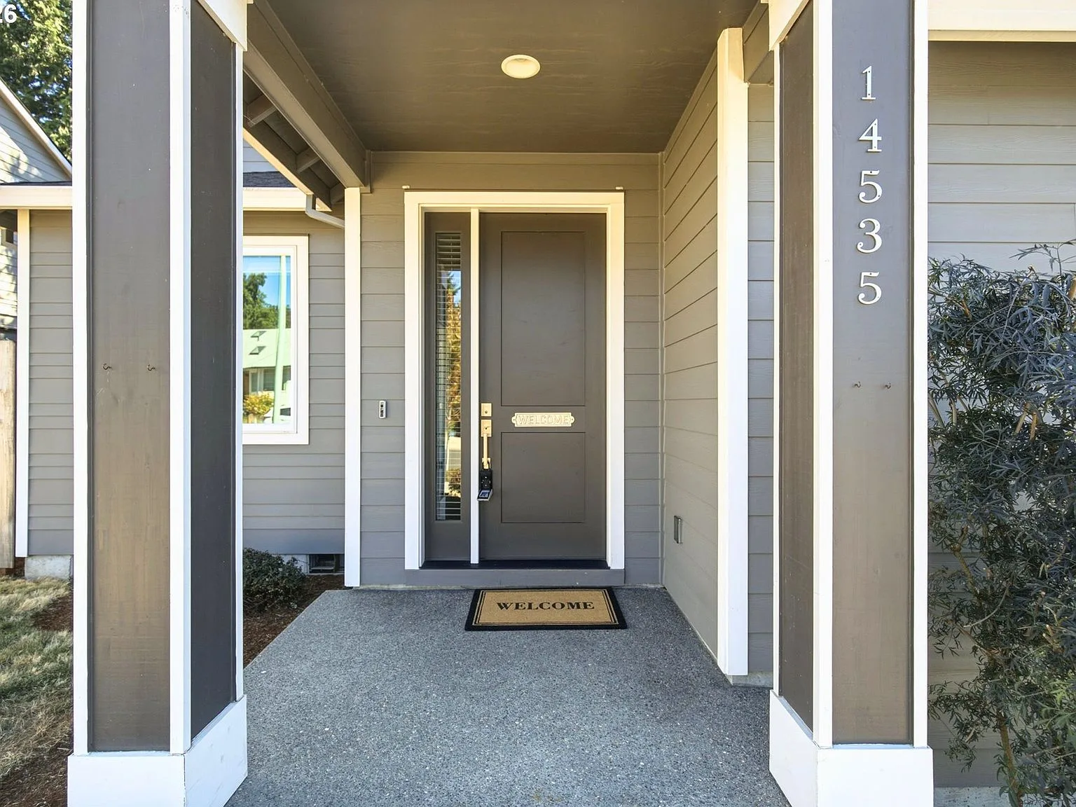 Front entrance with modern craftsman details and dark-painted trim