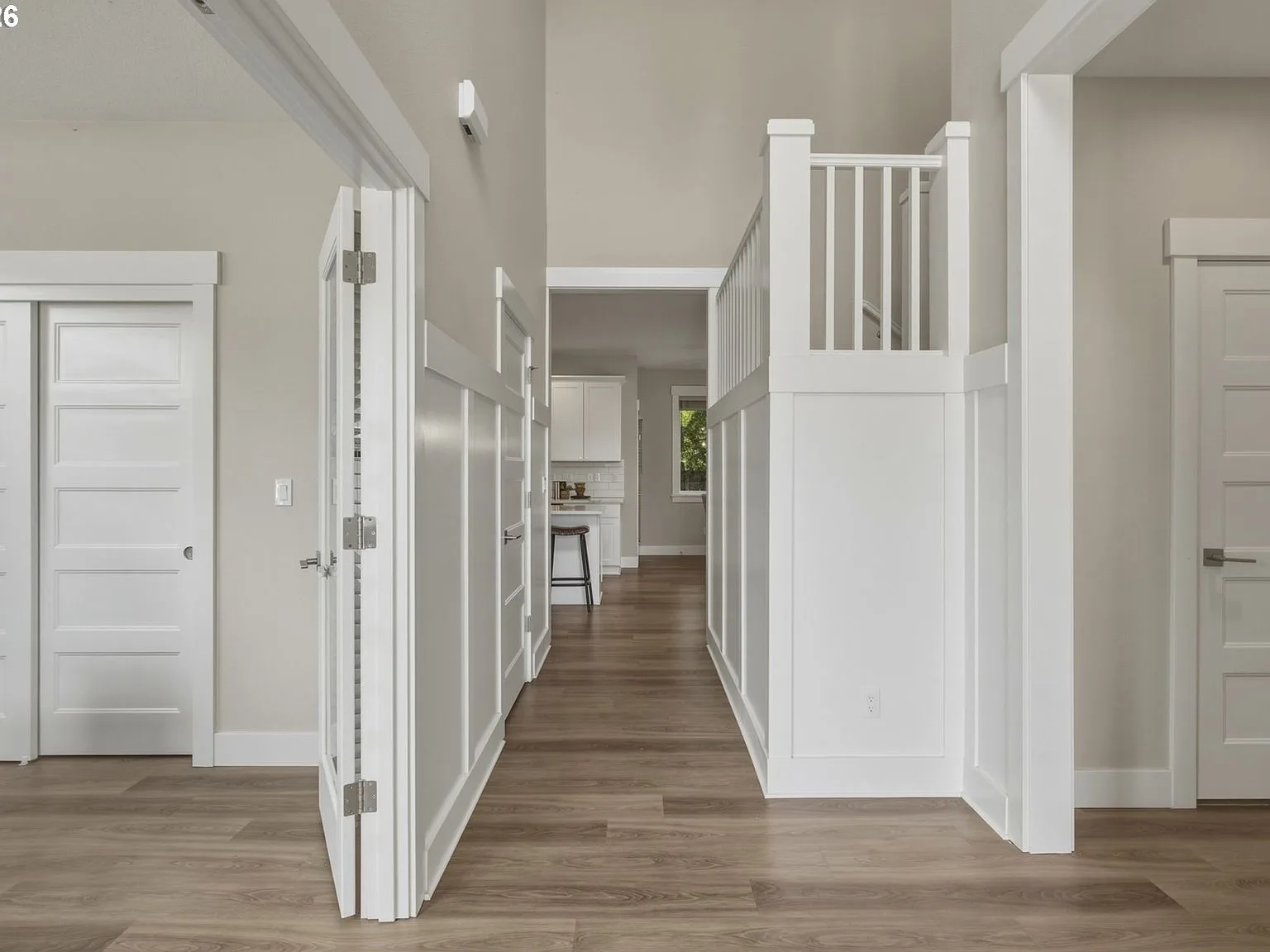 Modern entry hallway with staircase and wood flooring