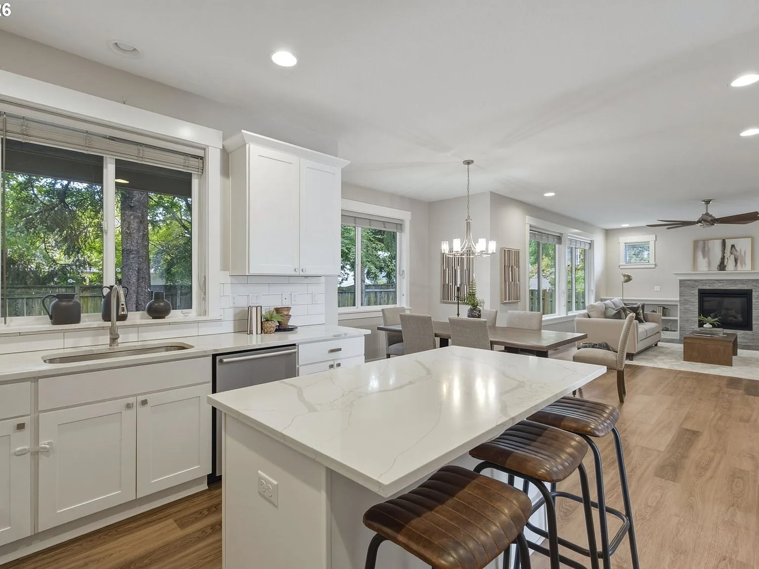 Open-concept kitchen, dining, and living area with natural daylight