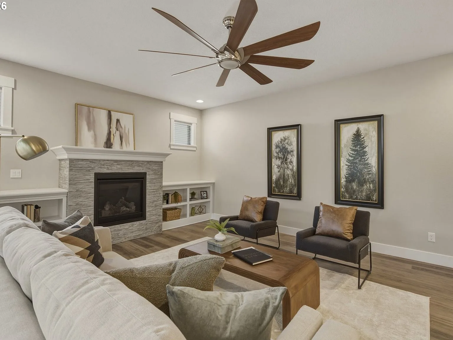 Living room detail with stacked stone fireplace and natural wood built-in shelving
