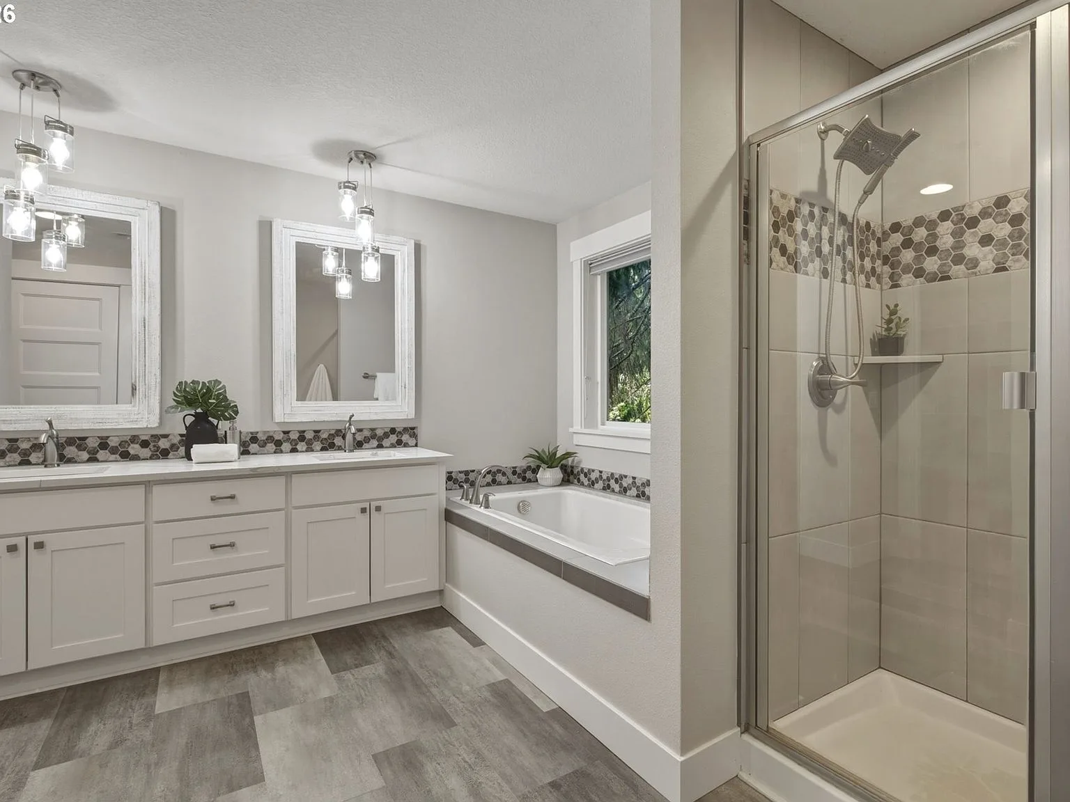 Primary bathroom with double vanity and soaking tub
