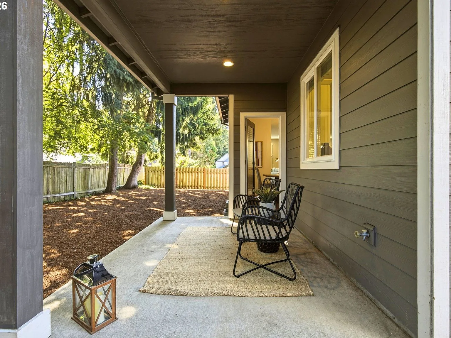 Covered patio with view of fenced backyard