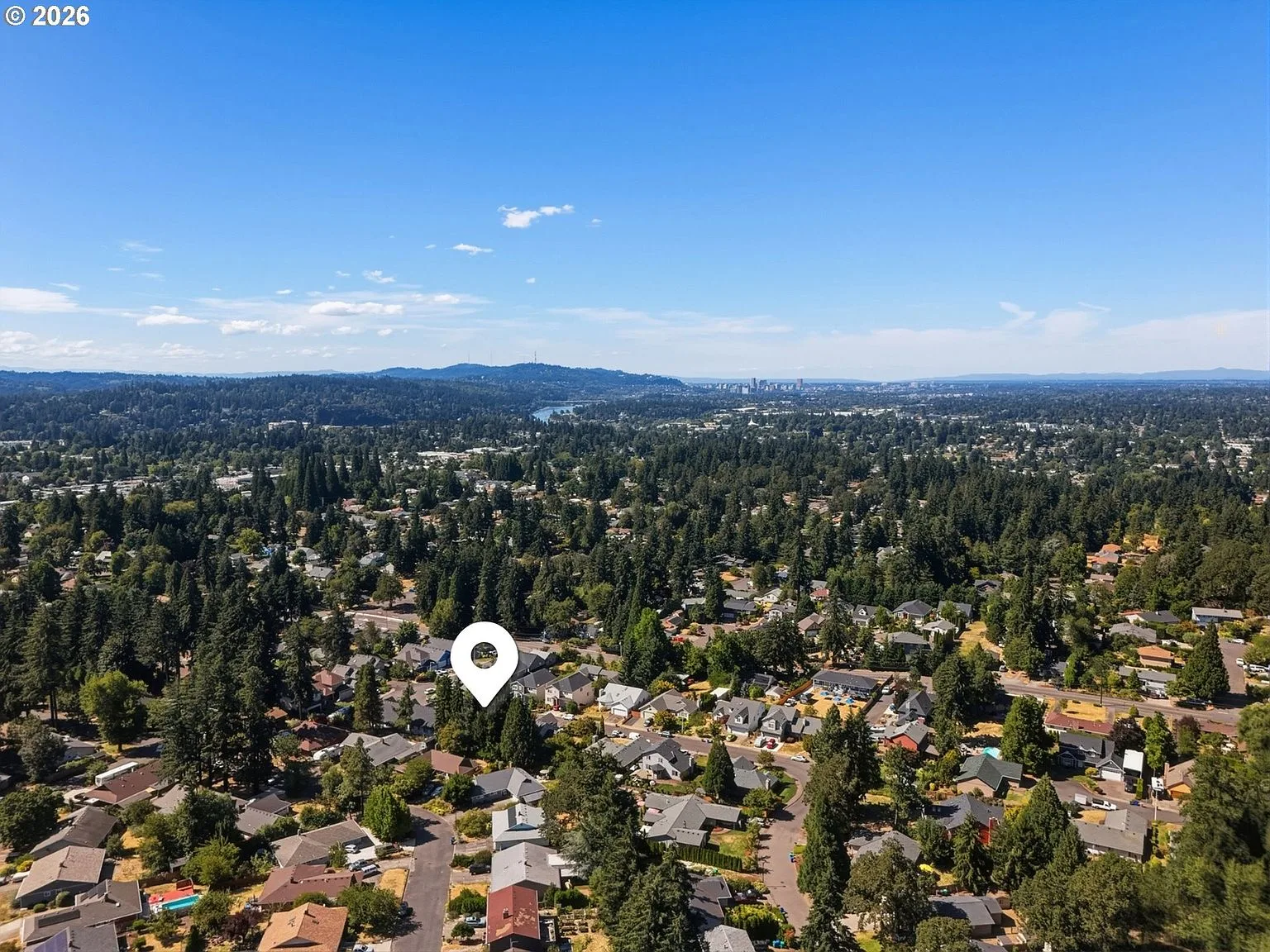 Aerial drone shot of the residential neighborhood with location pin overlay