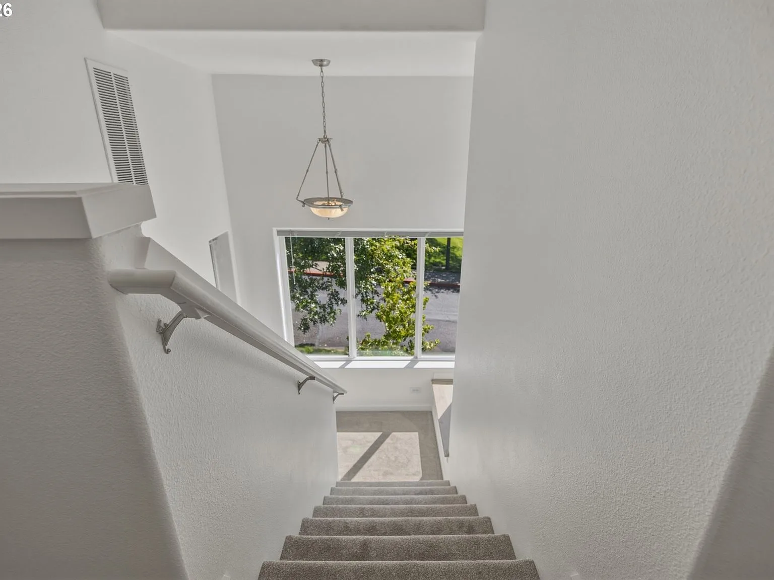 Stairwell with landing window and pendant light