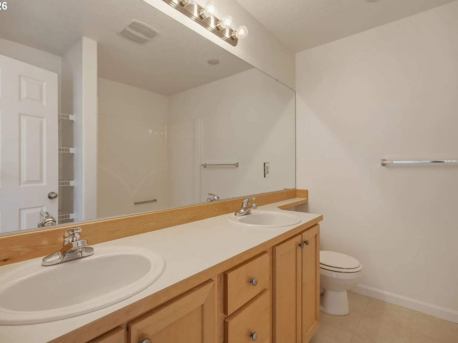 Bathroom with double vanity and large mirror