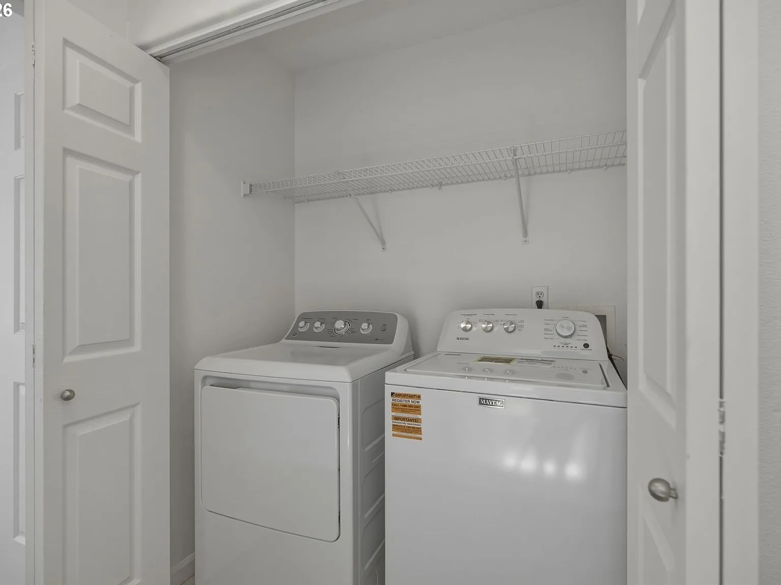 Laundry closet with bifold doors and wire shelving