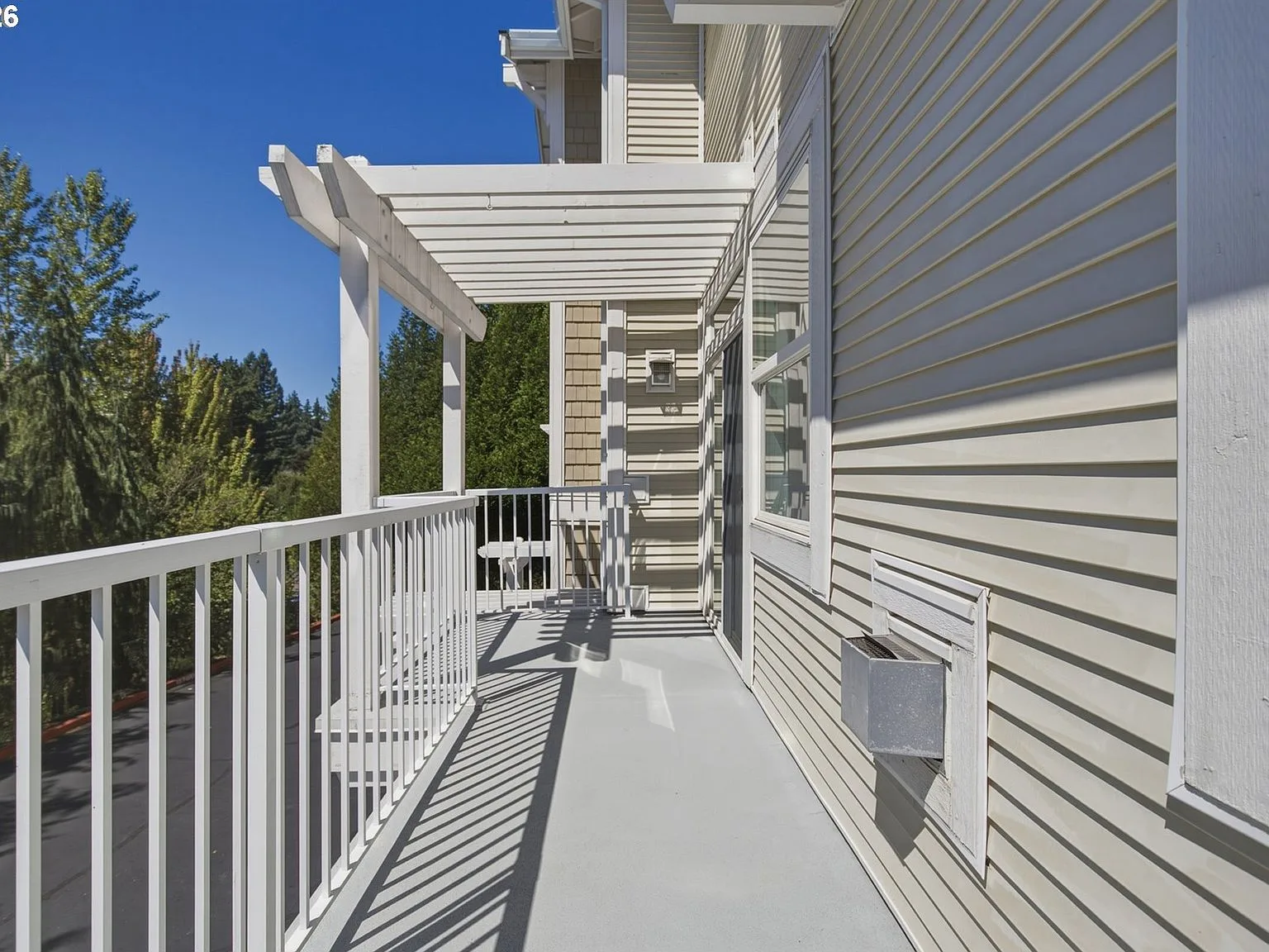 Side profile of balcony with white wooden pergola