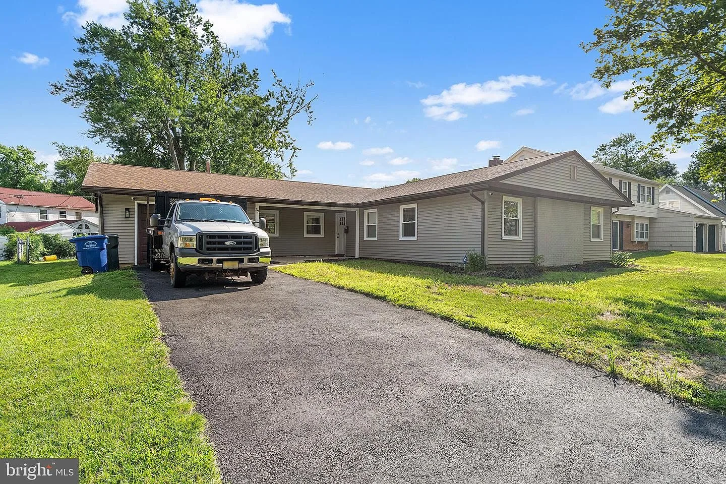 Renovated ranch home at 57 Eastbrook Lane, Willingboro NJ — street-level exterior view with grey siding and blue sky