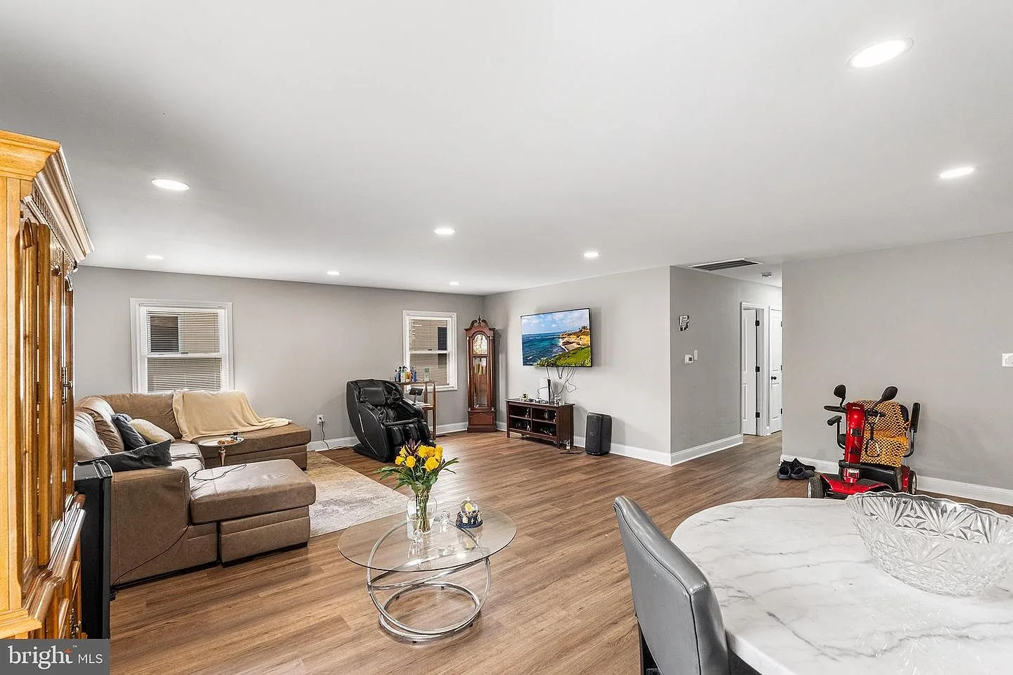 Open-concept living and dining room with recessed lighting and luxury vinyl plank flooring