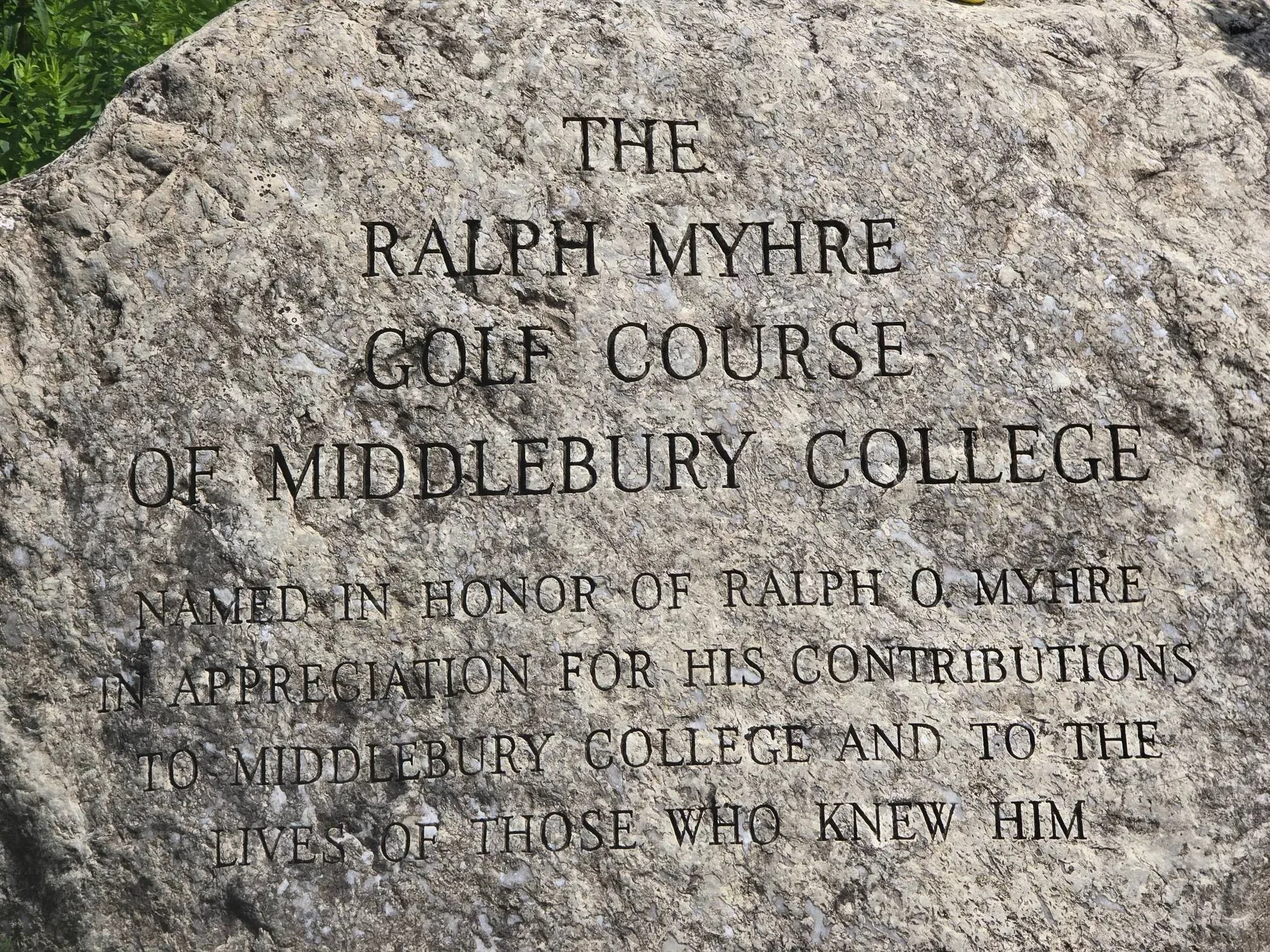 A memorial stone marks the entrance to the Ralph Myhre Golf Course