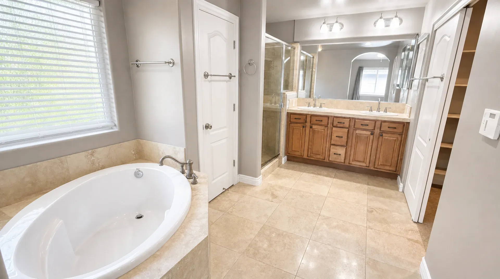 Primary bathroom with soaking tub, dual vanity, and glass shower